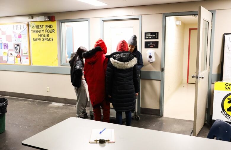 A group of people grouped up around a man.