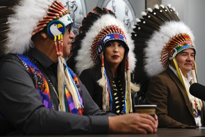 Aly bear is at a table with two other chief beside her