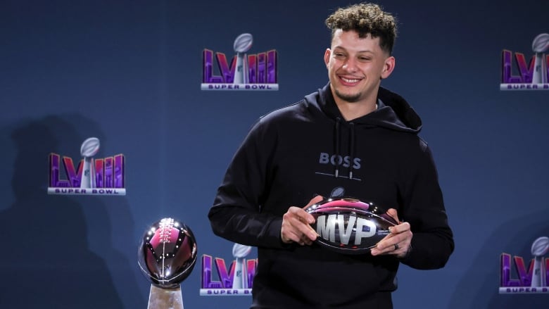 Male NFL quarterback poses with the MVP award during a news conference for the winning head coach and MVP of Super Bowl LVIII at the Mandalay Bay Convention Center on Feb. 12, 2024 in Las Vegas, Nevada. 