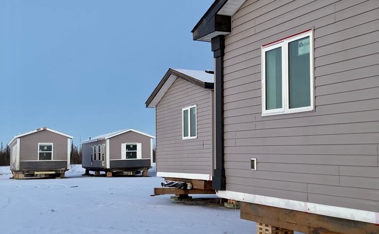 4 prefab homes sit in a field