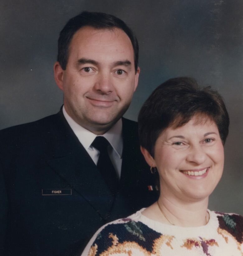 A woman and man pose for a portrait. 