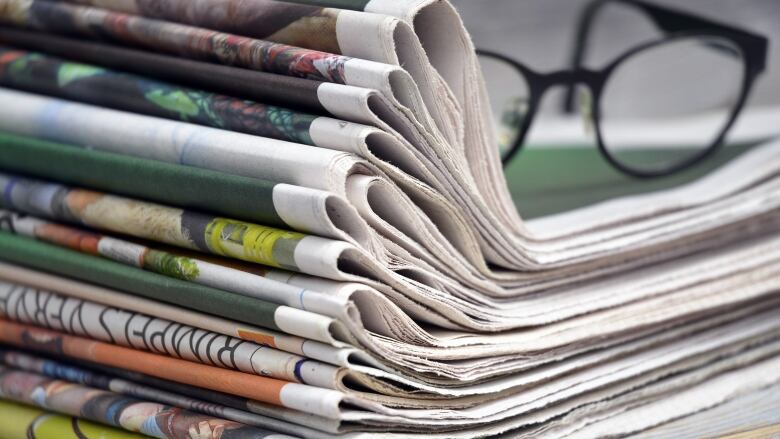 Newspapers on a desk.