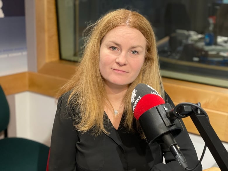 A woman speaks into a CBC microphone