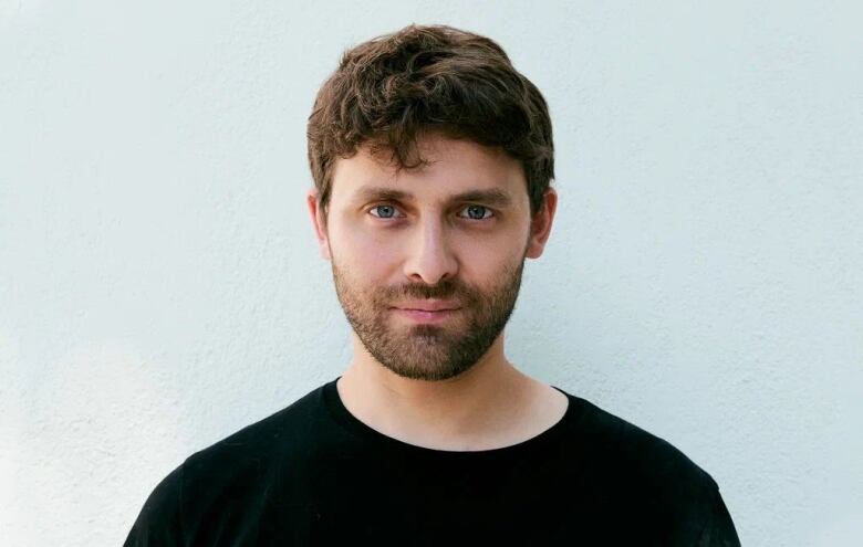 Portrait of a bearded man in a black T-shirt