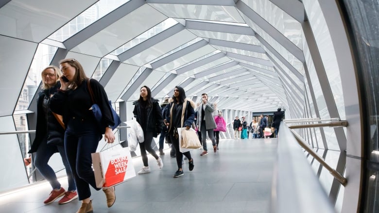 Statistics Canada says there are now more millennials than baby boomers in the country, ending the 65-year rein of the post-World War II generation as the largest in the population.People walk in an overhead pedestrian crossing in Toronto on Thursday, Dec. 26, 2019.