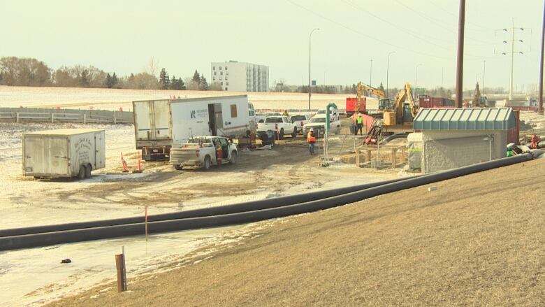 Construction crews work at a site new a river.