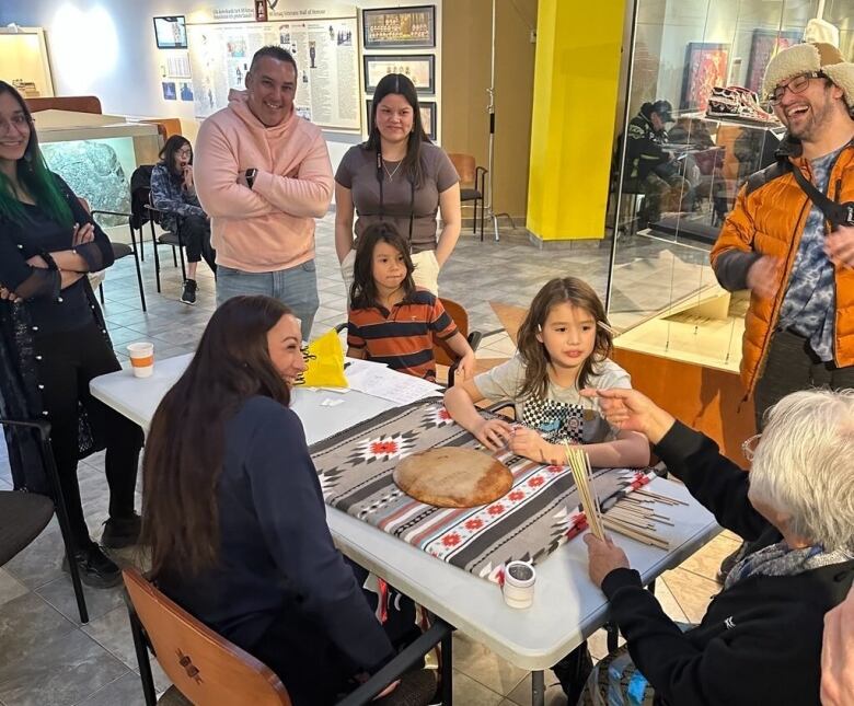 People smiling around a board game