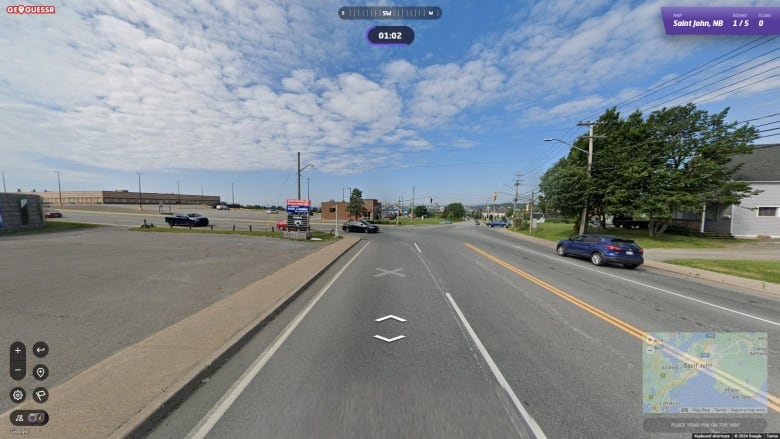 A Google Streetview photo of a road with a brown building in the distance.