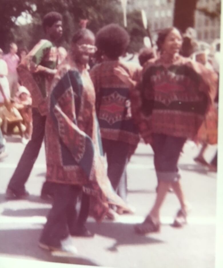 Smiling young people in matching patterned clothes.