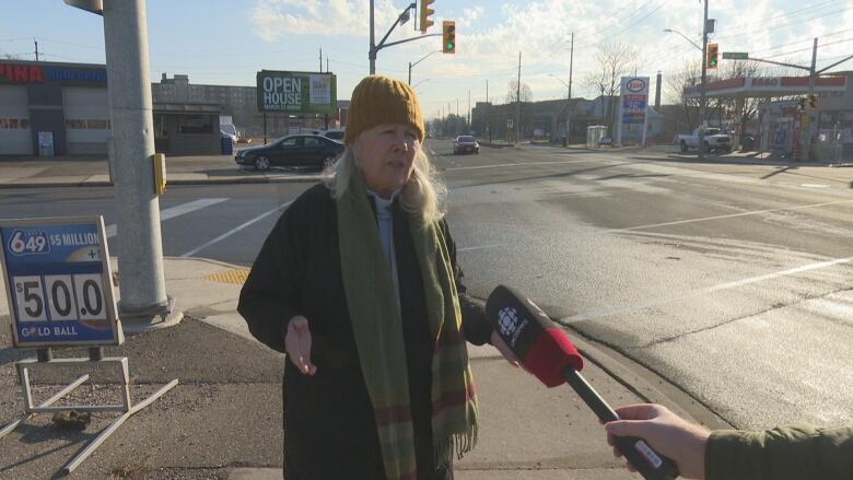 Lori Newton stands on the corner of Wyandotte Street East and Strabane where the bike lane abruptly ends. 