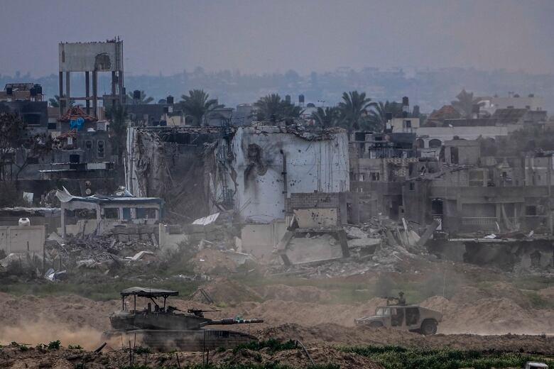 Israeli soldiers operate inside the Gaza Strip, as seen from southern Israel, Tuesday, Feb. 13, 2024. 