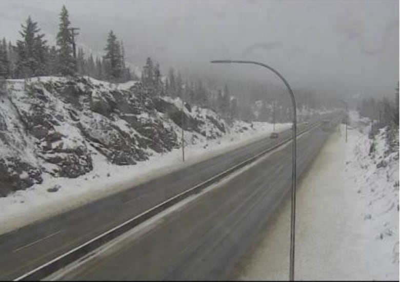 A highway camera shows a snowy mountain highway.