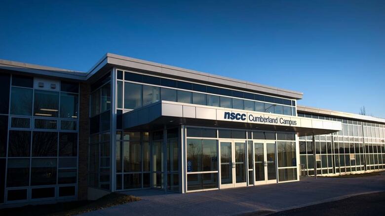 A glass and metal entrance to a community college.