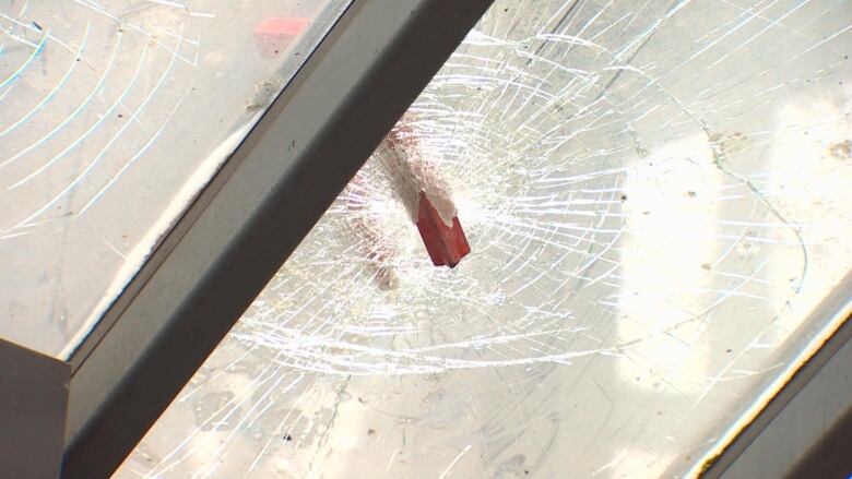 A piece of metal smashed through glass.