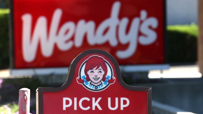 A sign for a Wendy's drive-thru that reads 