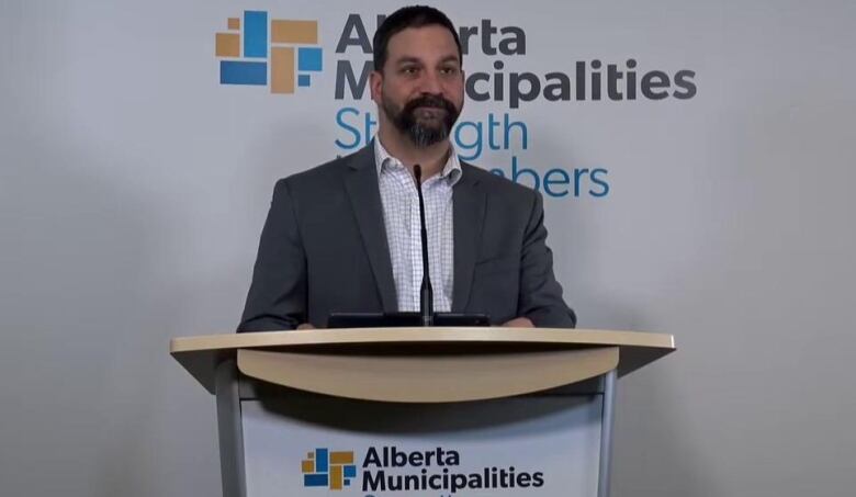 A man stands behind a podium.