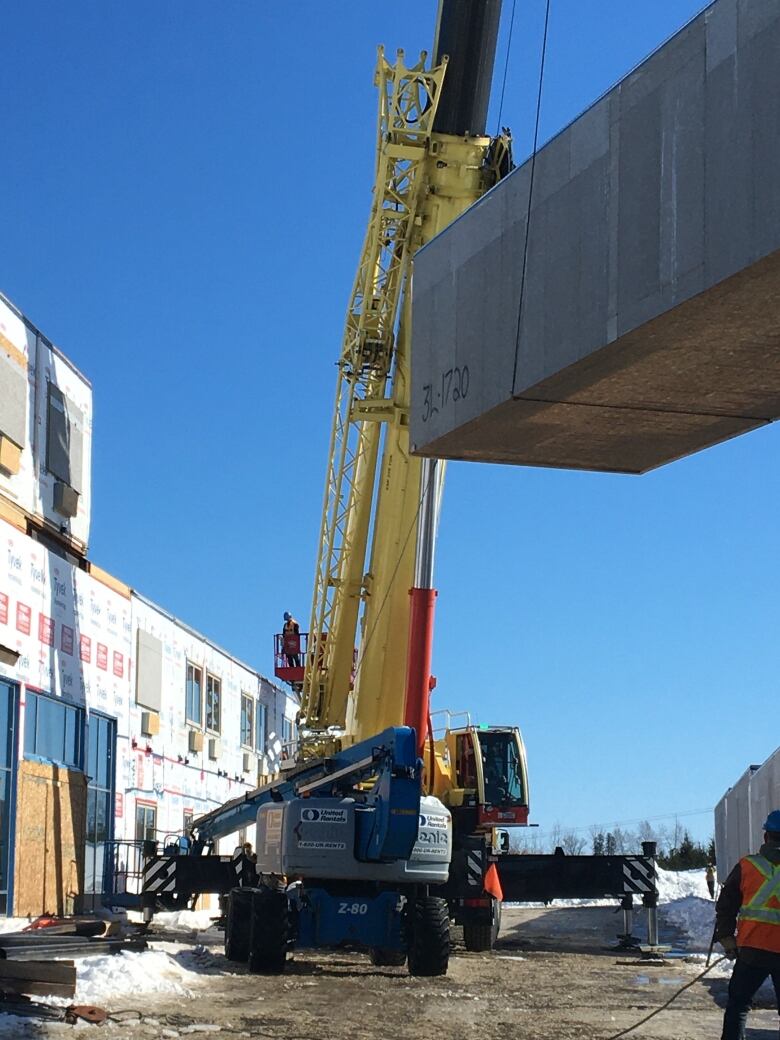 Modular hotel under construction with crane