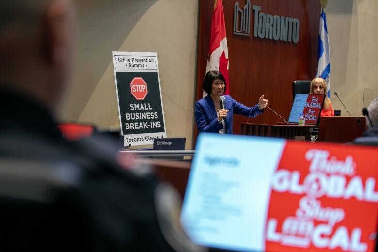 Mayor Olivia Chow stands in city hall chambers.