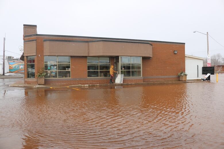 A very brown photo of a submerged Tim Hortons. 