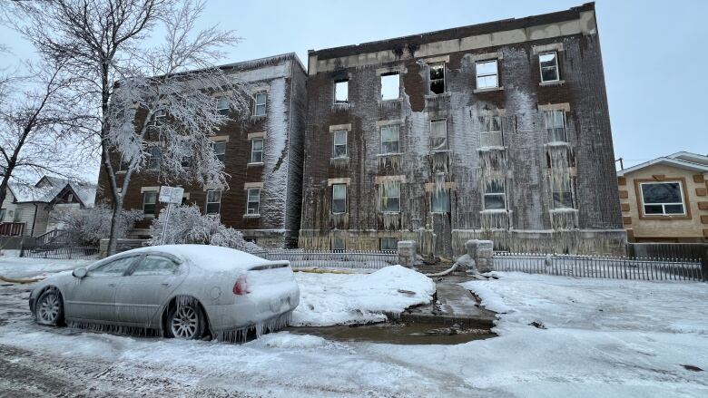 A three storey brick apartment building covered in ice following a fire. 