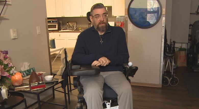 A man sitting in a wheelchair is pictured.