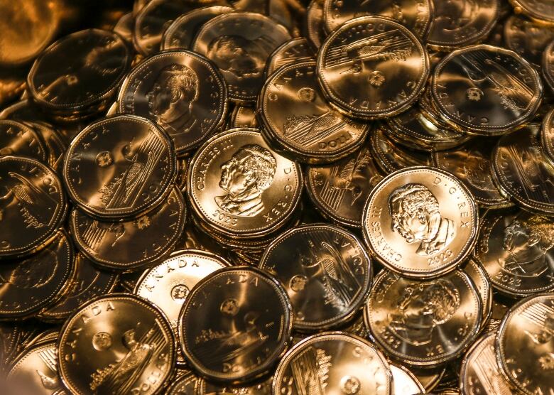 Loonies with the the effigy of King Charles on them are struck at an event celebrating the first coin struck at the Royal Canadian Mint in Winnipeg on Tuesday, November 14, 2023.