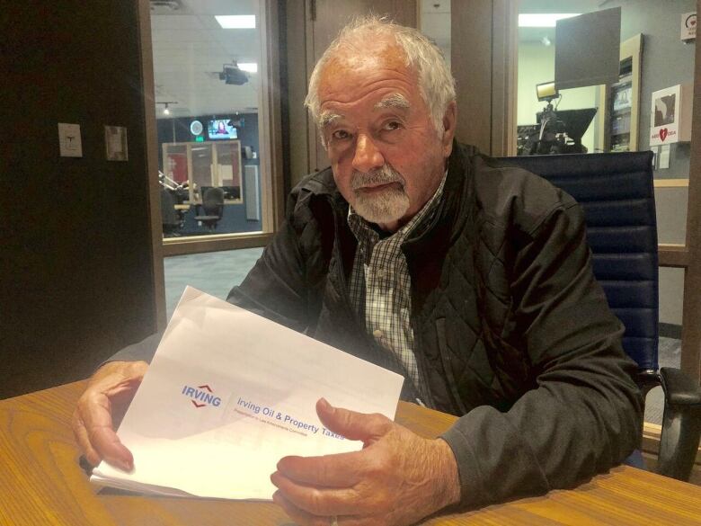 Jerry Lowe holds a document from Irving