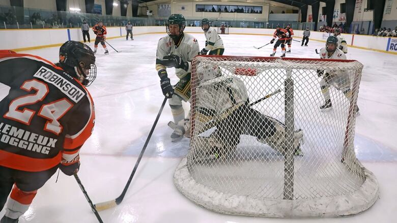 hockey action behind the next in a small arena 