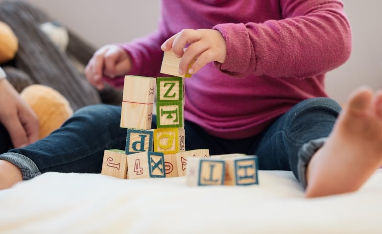 A baby plays with blocks.