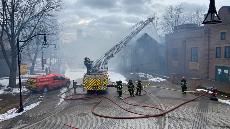 Firefighters battle a fire on Carleton Street in Fredericton.