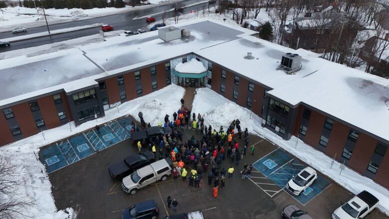 Aerial view of group of people gathered in parking lot