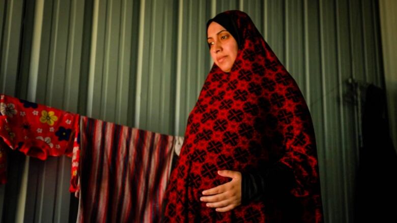 Alaa Jabr, 30, is eight months pregnant and living in a displaced persons camp in Rafah.  During her difficult pregnancy,  she has had to move several times,  suffers from malnourishment and dehydration. 