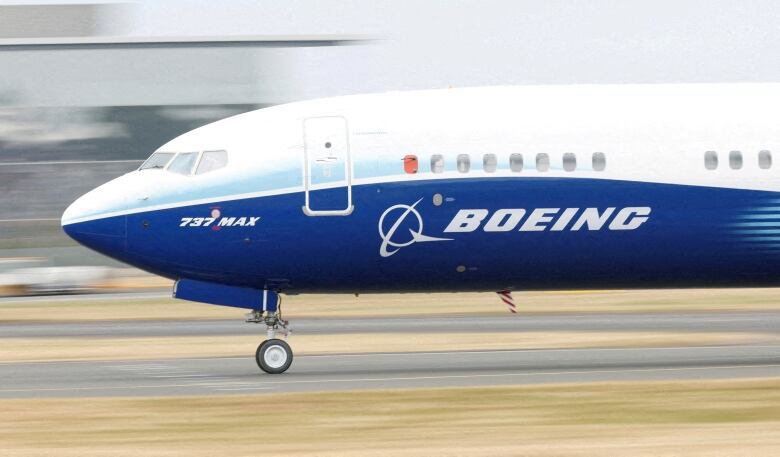 A Boeing plane is shown taxiing on a runway.