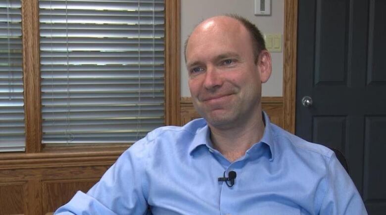 A man in a blue dress shirt