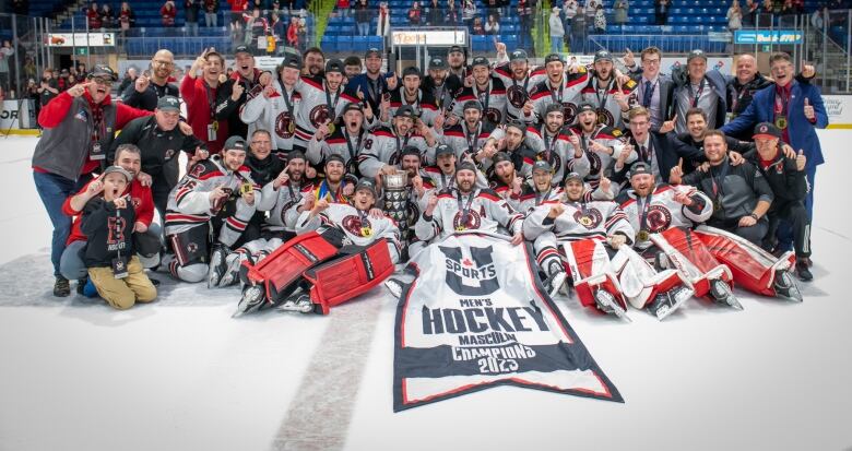 A hockey team with a 2023 championship banner 