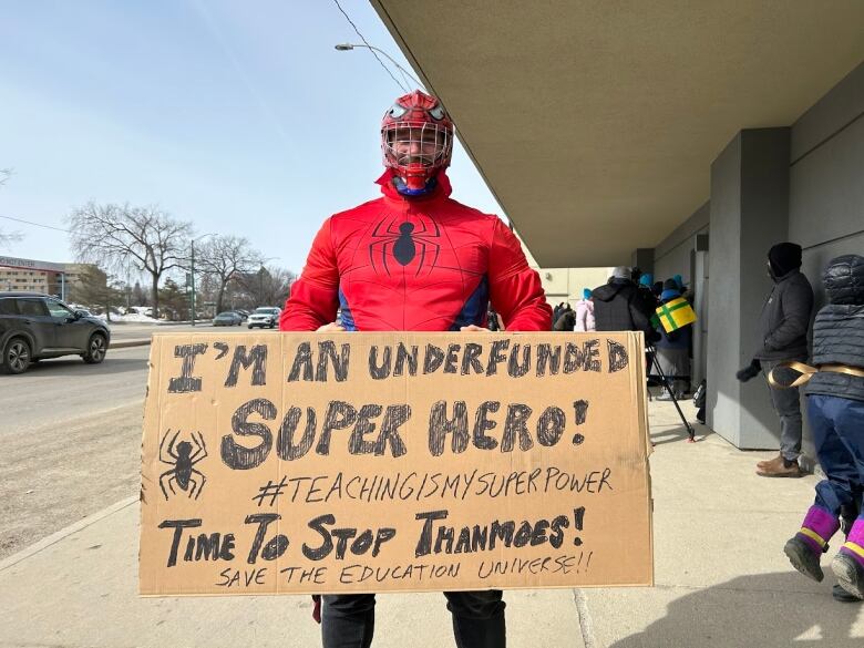 A man holding a protest card.