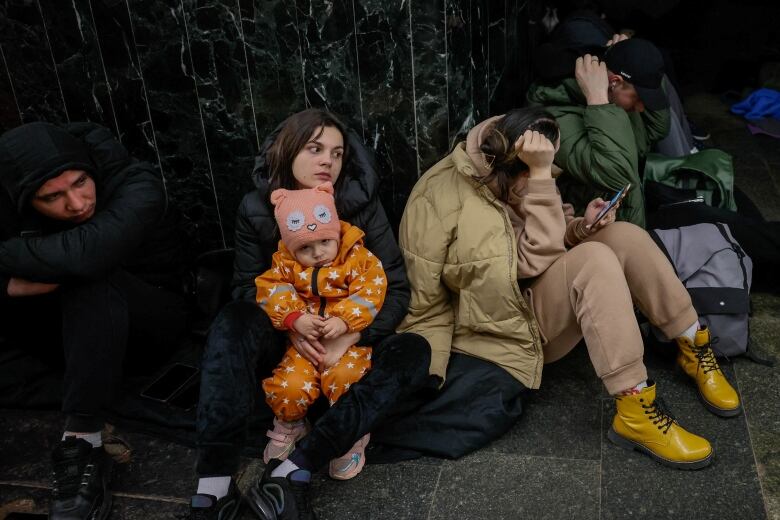 People take shelter inside a metro station during a Russian missile strike, amid Russia's attacks on Ukraine, in Kyiv, Ukraine, March 21, 2024.