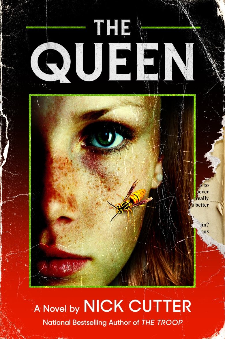 A torn red book cover featuring a bee on a woman's face.