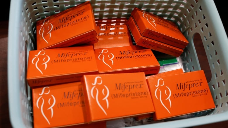 A basket container with several small boxes with the label Mifeprex (Mifepristone) is shown.