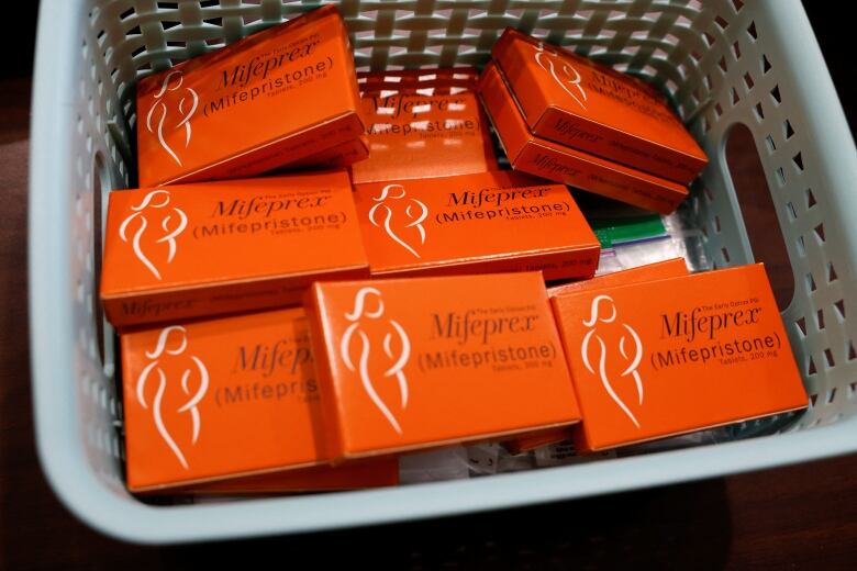 A basket container with several small boxes with the label Mifeprex (Mifepristone) is shown.