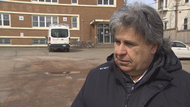 Mitch Tweel standing in front of the former curling club and outreach centre on Euston Street.