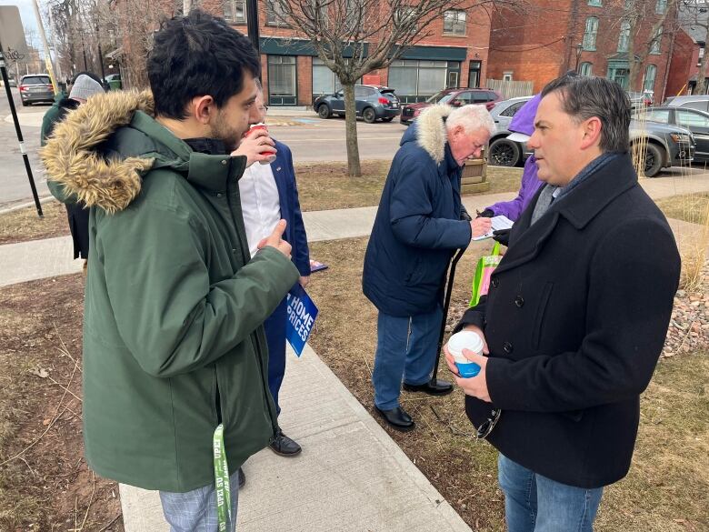 Aidan Mousavin, left, talks with Miramichi-Grand Lake Conservative MP Jake Stewart