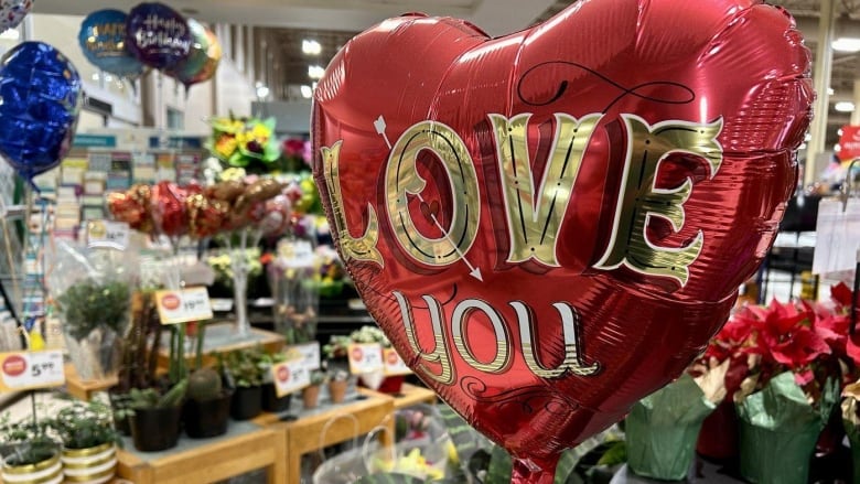 Flowers and balloons in a store.