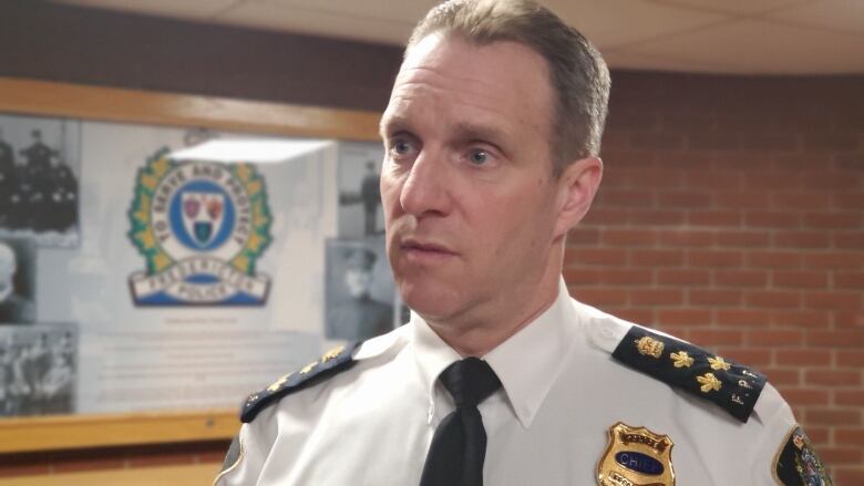 Martin Gaudet speaks inside the lobby of the Fredericton police headquarters.