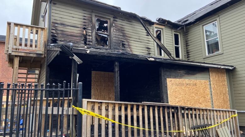 A wooden building damaged by fire.