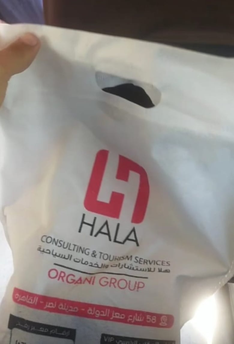 A plastic bag with Arabic writing shows the Hala logo says Hala Consulting & Tourism Services, Organi Group. 