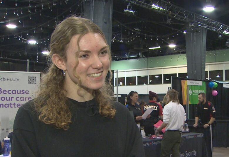 a young woman in a black sweater.