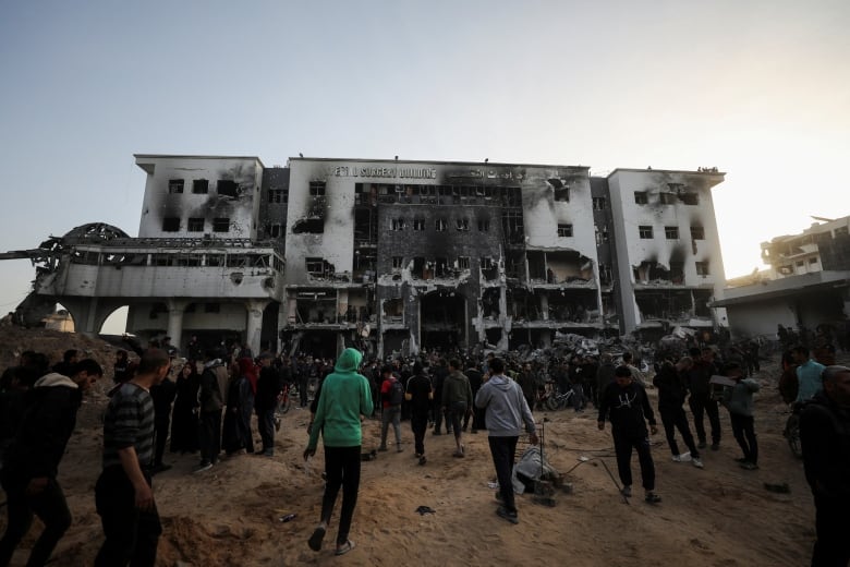 Palestinians inspect the damage at Al-Shifa Hospital in Gaza City. 