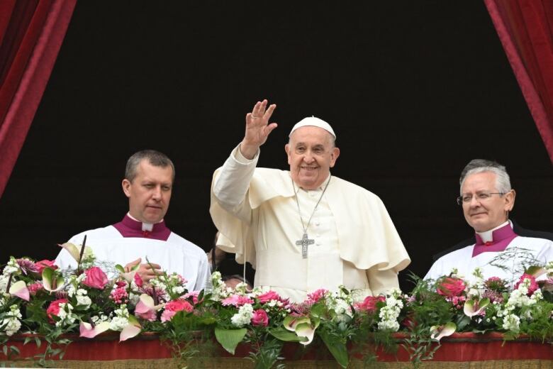 Pope Francis, centre, waves to the crowd in St. Peter's Square.