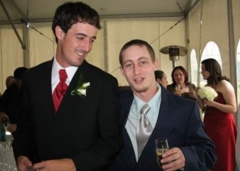 Two men in suits at a wedding or prom-type event.